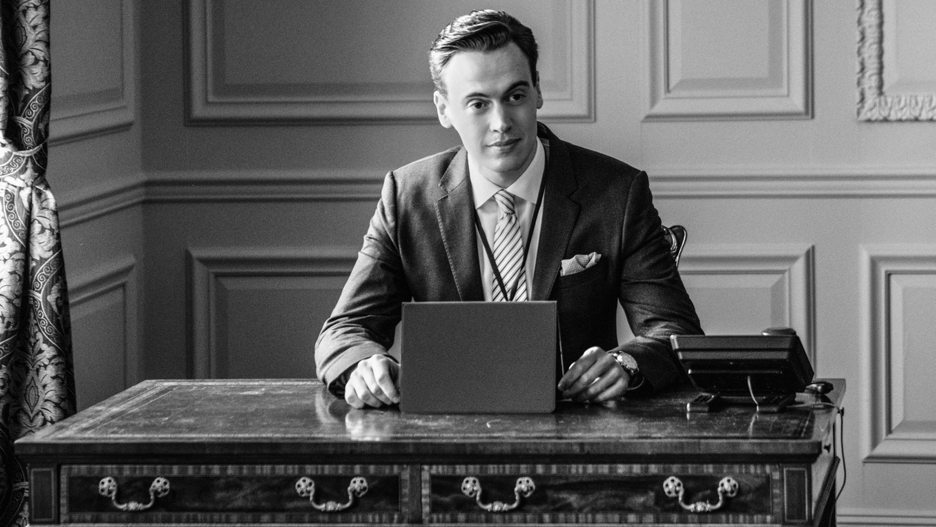 This sophisticated snapshot shows Erich Bergen as Blake Moran in black and white.