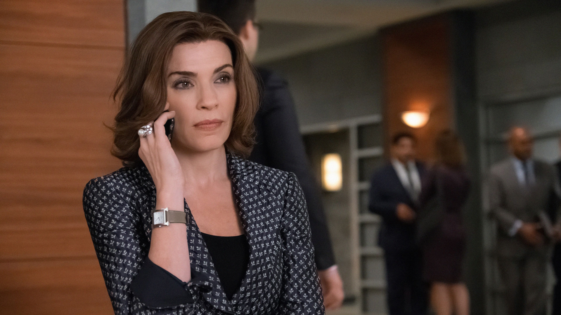 Alicia Florrick receives a call outside of court.